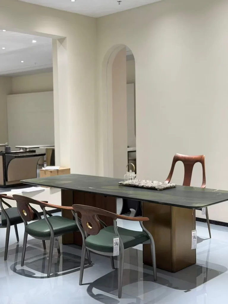 green stone dining table, with a plain surface, in a showroom