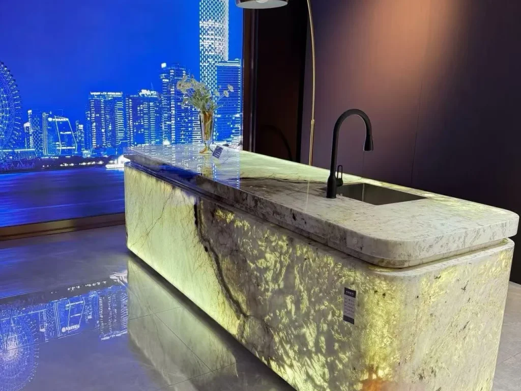 cream-beige stone countertop, with bold veining and a reflective finish, in a showroom