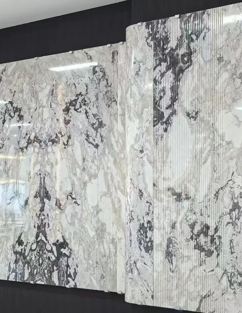 white stone slab, with bold veining and a reflective finish, against a dark background