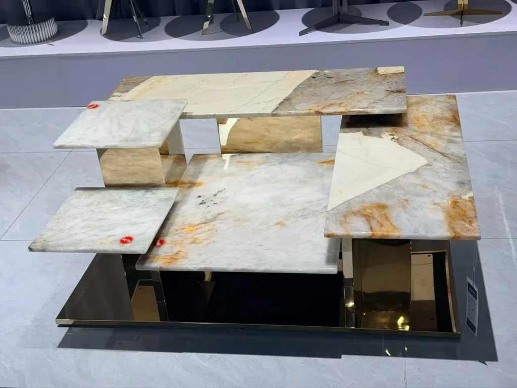 cream-beige stone coffee table, with fine veining and a reflective finish, in a showroom