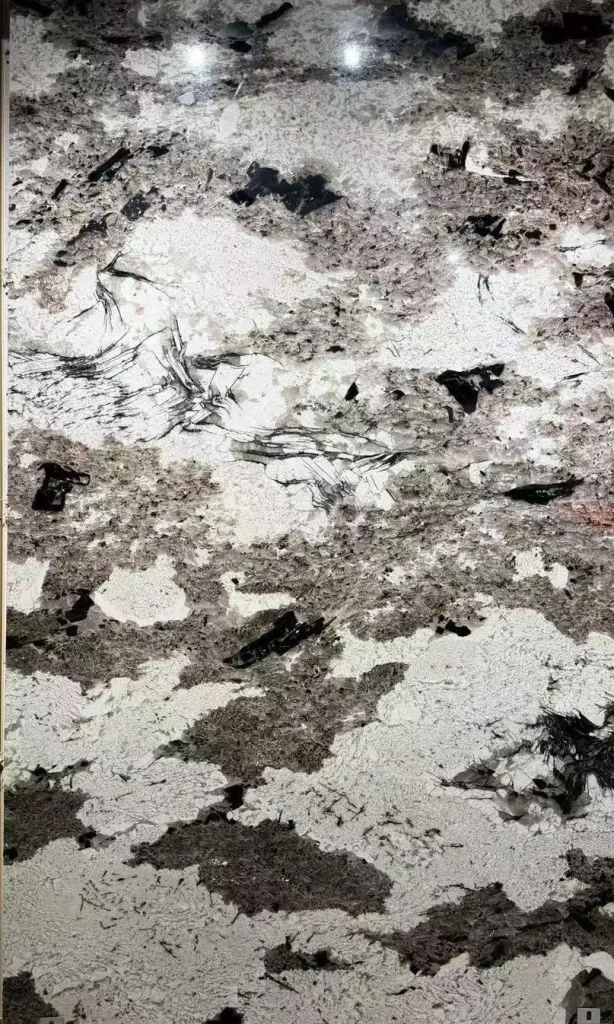 white stone slab, with cloudy mottling and a reflective finish, in a close surface view