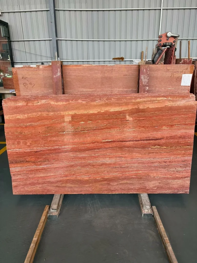 Red travertine dining table with linear veining
