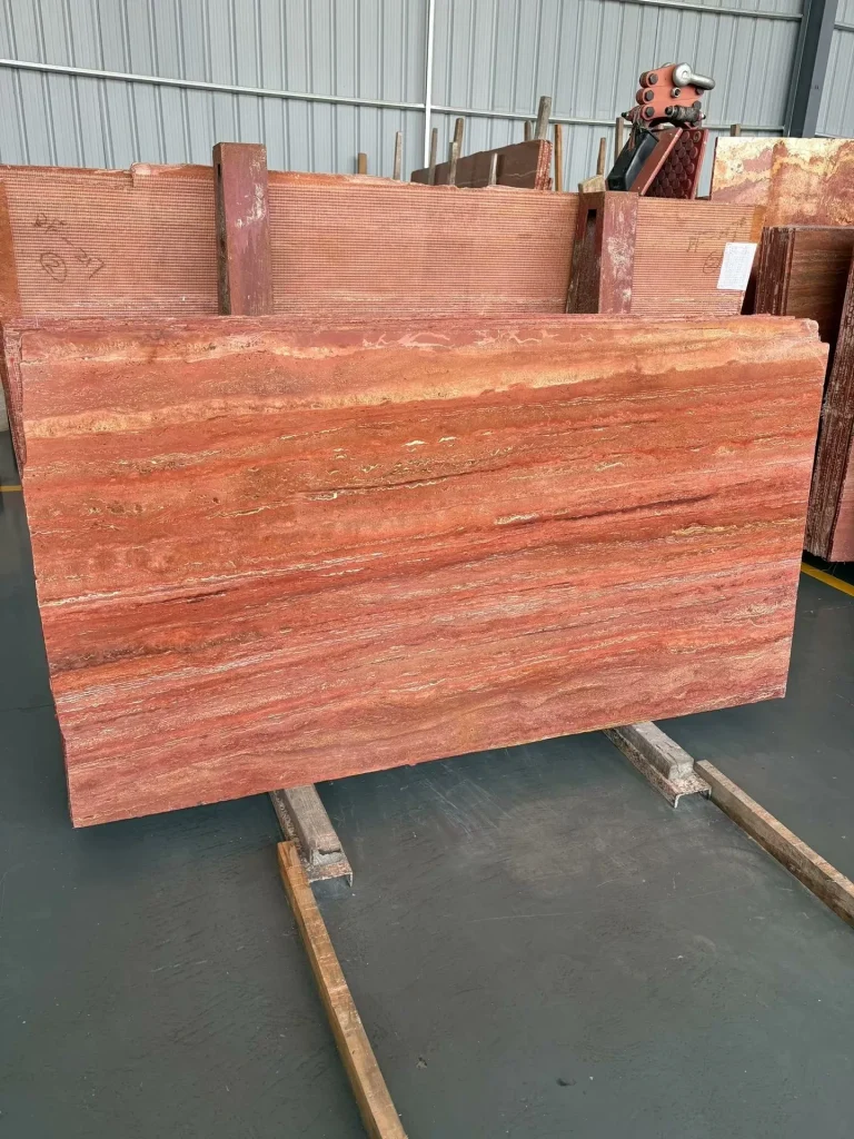 Red travertine dining table with linear veining