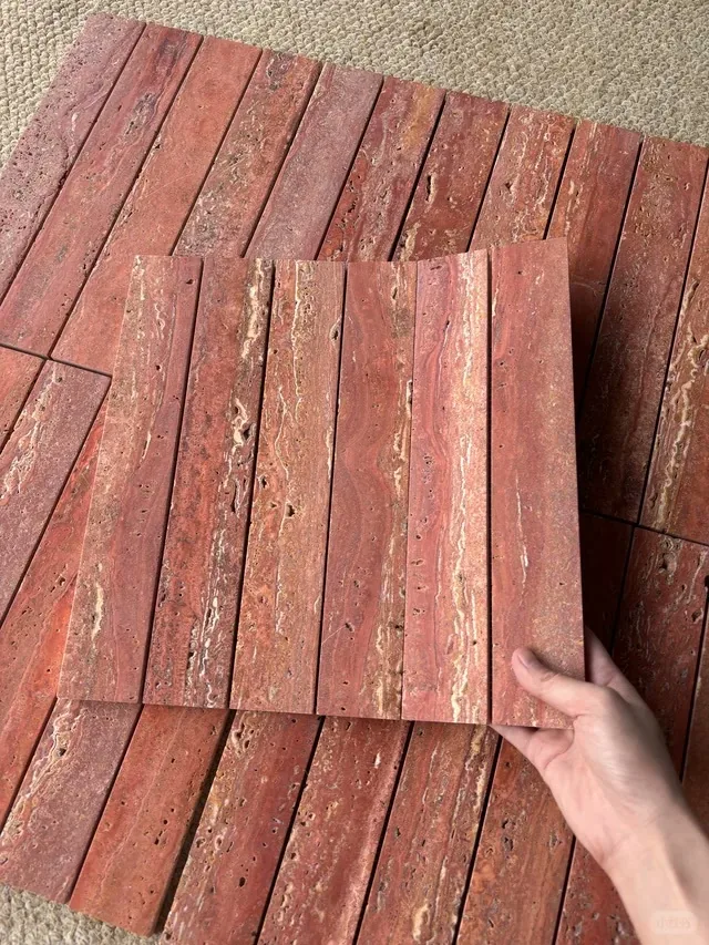 Red travertine slab with linear veining