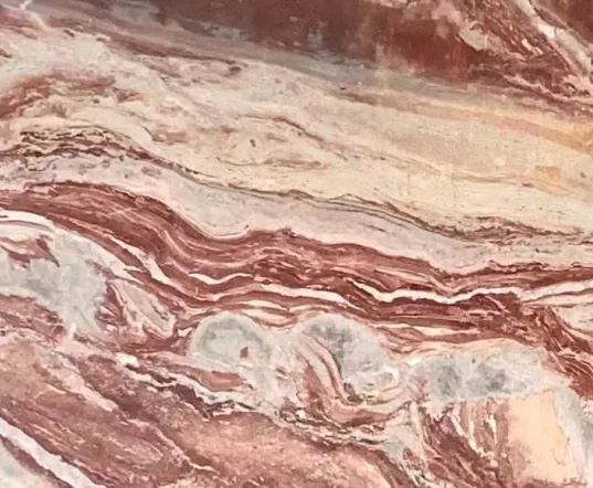 rose-red stone slab, with banded onyx-like striping, in a close surface view
