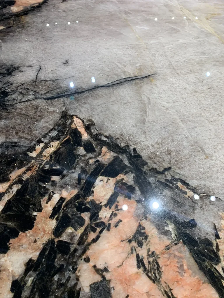 Smoke pink stone dining table with cloudy veining