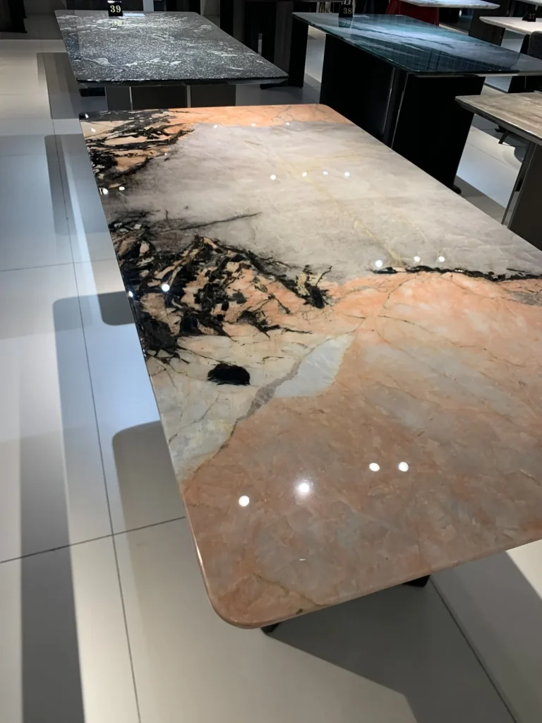 Smoke pink stone dining table with cloudy veining
