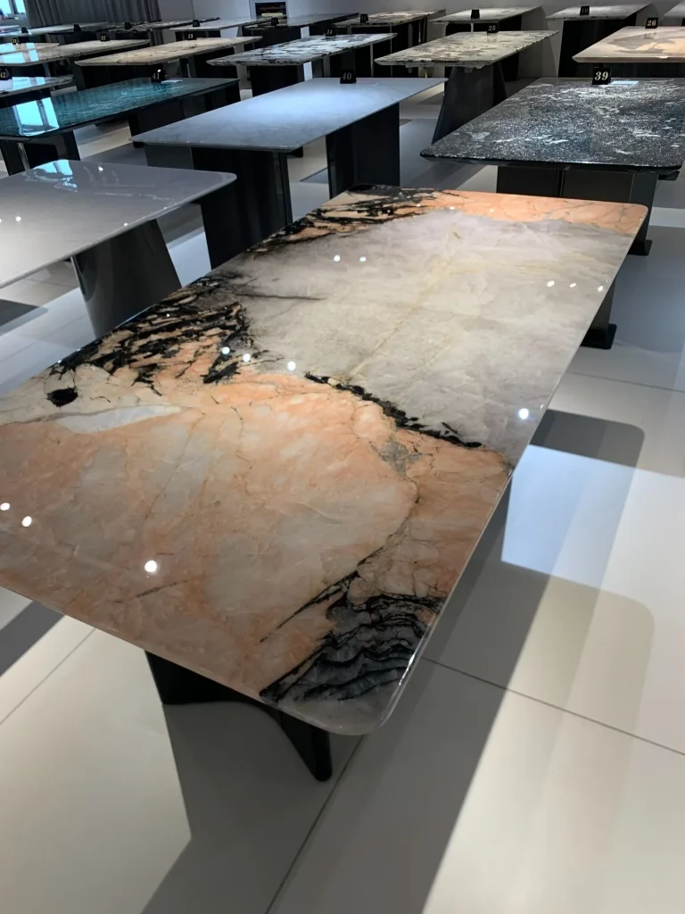 Smoke pink stone dining table with cloudy veining