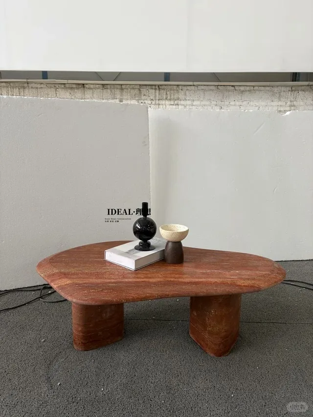 Red travertine coffee table with linear veining