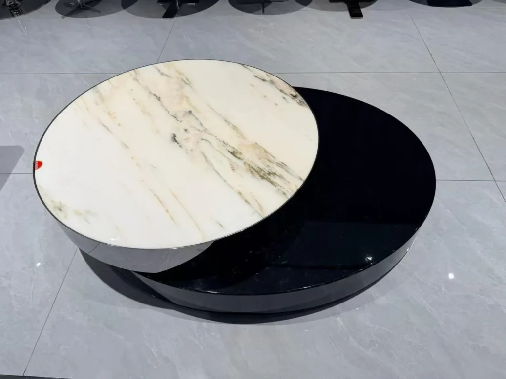 white stone coffee table, with a round top and bold veining, in a showroom
