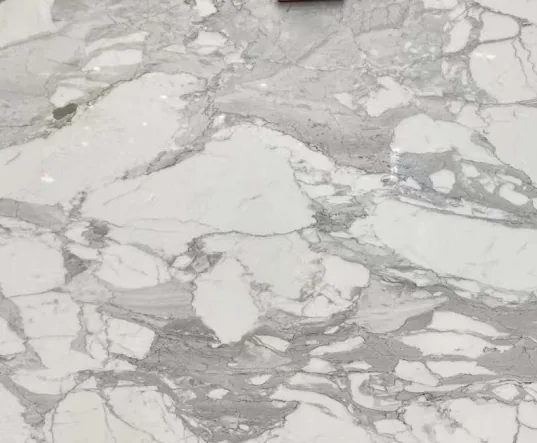 white stone slab, with broad sweeping markings and an uncluttered setting