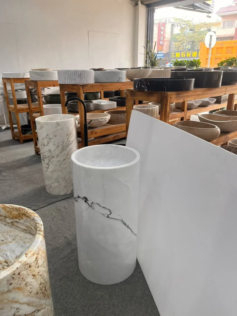 white stone sink, with fine veining, in a showroom